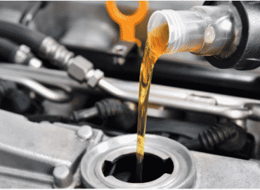 putting oil into a car