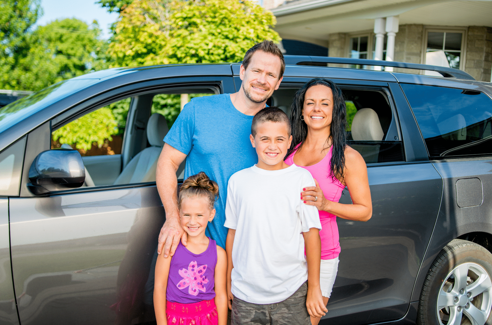 happy family in front of car